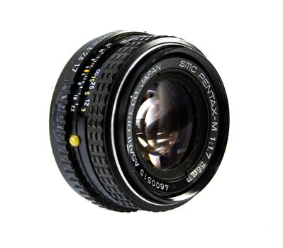 An old manual control camera lens isolated on white.