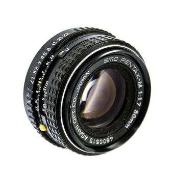 An old manual control camera lens isolated on white.