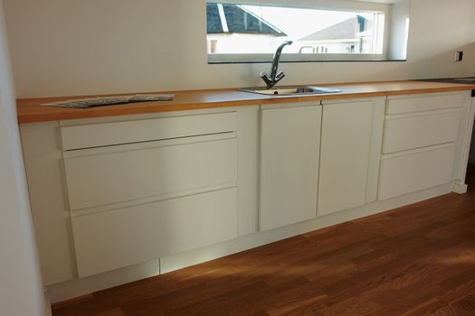 Modern design trendy kitchen with white and wood elements                                