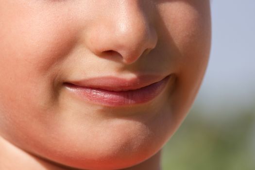 Child plays a cheerful smile without showing teeth