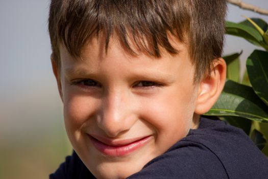 Child plays a cheerful smile without showing teeth