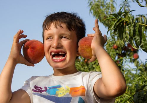 Child plays a cheerful smile without showing teeth