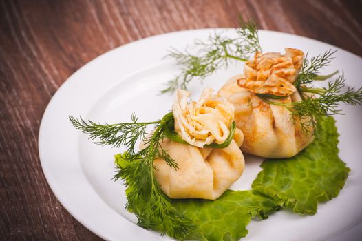 eastern european stuffed pancakes served on white plate