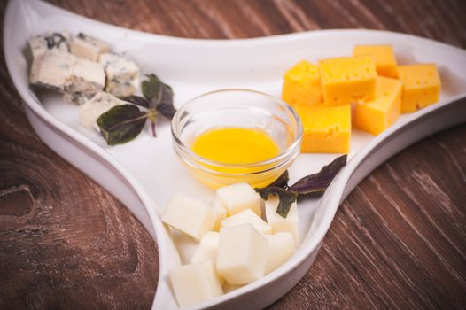 cheese platter with jam on white plate 