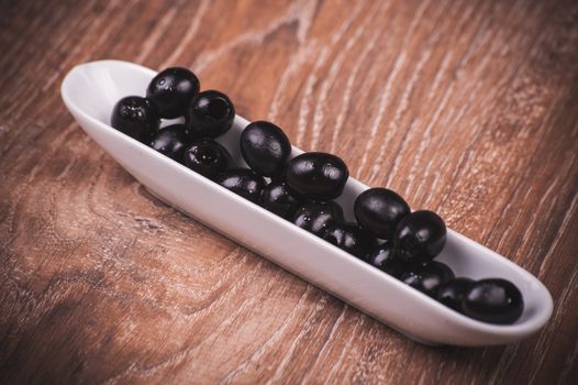 black olives without bone in white plate