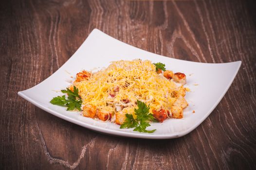 salad with bacon, crouton and cheese on white plate 