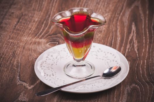 layered jelly desert in glass with spoon