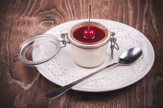 cherry panna cotta in jar with spoon