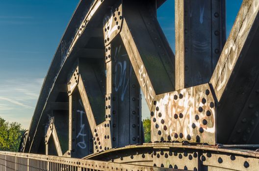 Riveted old arch of an old railway bridge.