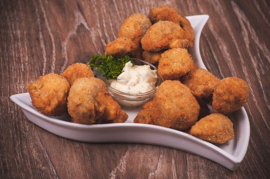 deep fried mushrooms with garlic sauce on white plate