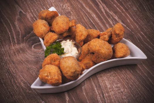 deep fried mushrooms with garlic sauce on white plate