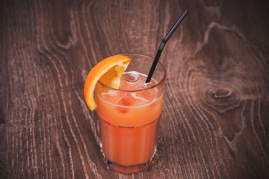 grapefruit fresh juice in glass with straw