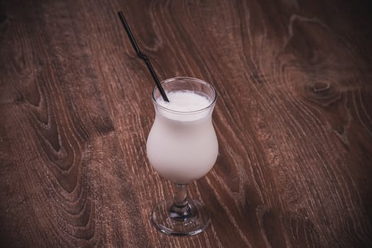 vanilla milk shake in glass with straw 