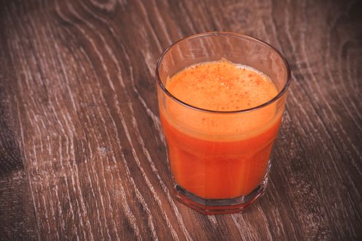 freshly squeezed orange carrot juice in glass 