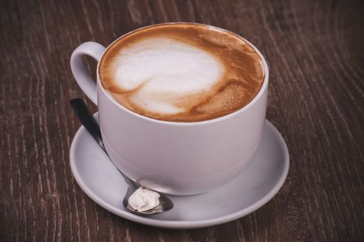 coffee cappuccino cup with milk foam with spoon 