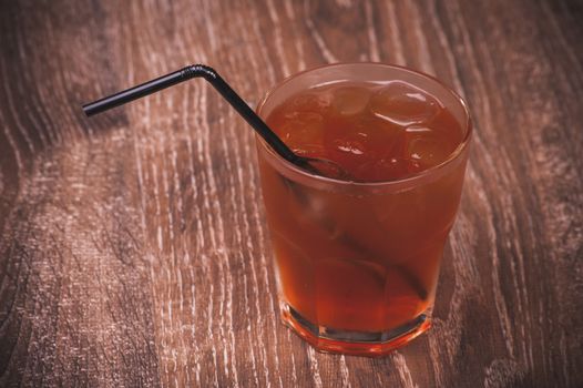 cold ice tea in glass with straw 