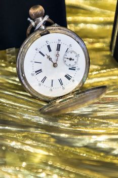 Image of a historic pocket watch on a gold background