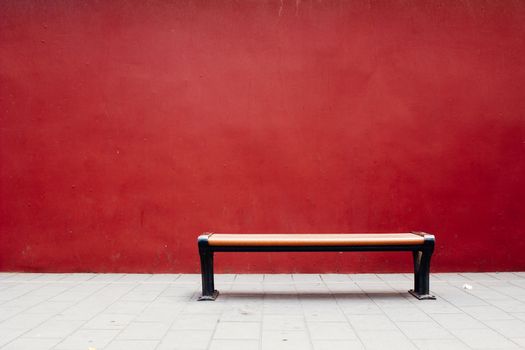 Bench in The Forbidden City with red wall