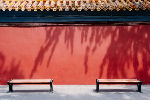 Bench in The Forbidden City with red wall