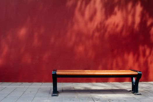 Bench in The Forbidden City with red wall