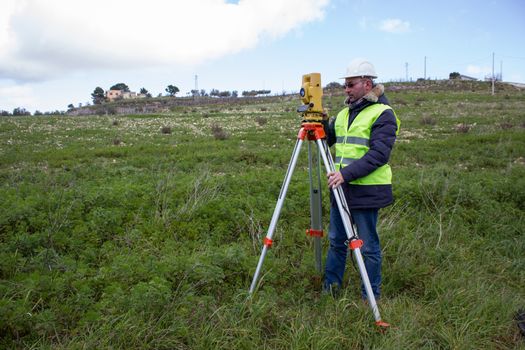 Engineer with a theodolite for measuring topographic