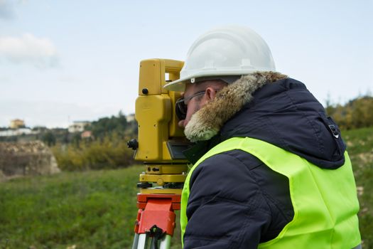 Engineer with a theodolite for measuring topographic