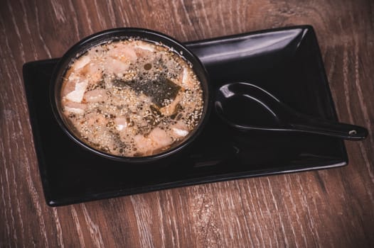 asian miso soup in bowl and spoon 