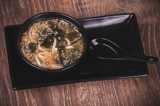 asian miso soup in bowl and spoon 