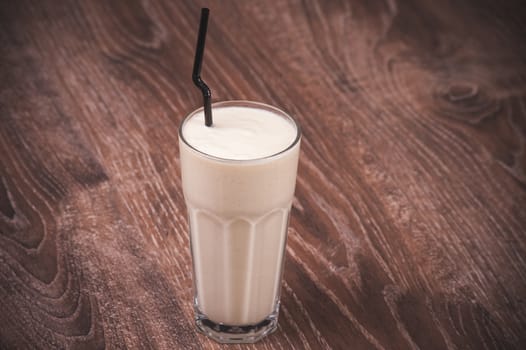 banana milk shake in glass  with straw 