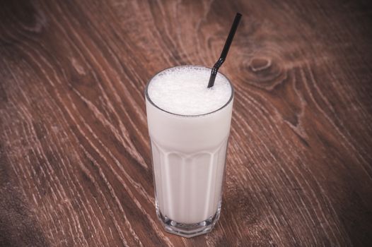 vanilla milk shake with straw  in glass 