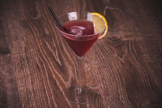 alcohol cosmopolitan cocktail in glass with straw 