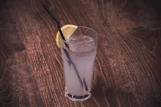 ice cold lemonade with lemon in glass