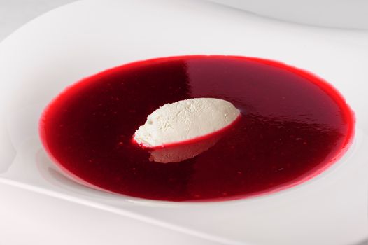 Portion of cold raspberry soup with mascarpone
