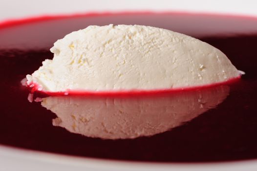 Portion of cold raspberry soup with mascarpone