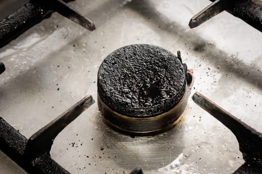 Real industrial kitchen, dirty gas burner closeup