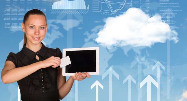 Beautiful businesswoman holding blank tablet PC and blank business card in front of PC screen. World map, clouds, vertical arrows and hi-tech graphs with various data as backdrop