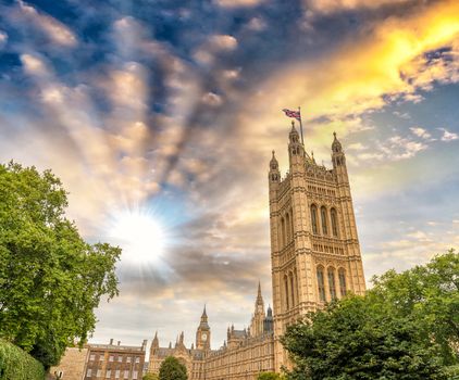 London, Westminster Palace surrounded by trees at dusk.