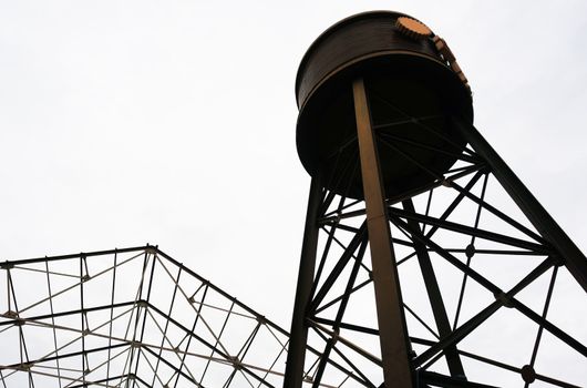 Water tank made of metal Placed on high level and bottom has steel frame.                               