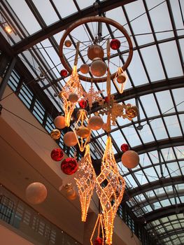 City shopping mall decorated for Christmas with shiny colorful balls and light