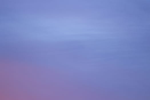 Sky with clouds in blue and pink sunset evening pastel colors rectangular photo. 