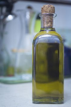 Bottle of extra virgin olive oil in kitchen on table in domestic house. 