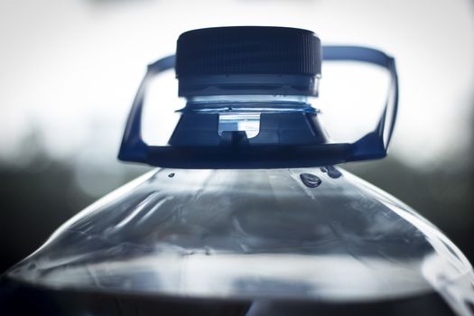 Isolated large plastic water bottle close-up photo. 