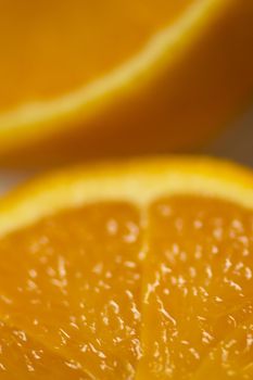 Closeup macro photo of Spanish Valencian orange cut in half looking juicy and delicious. 