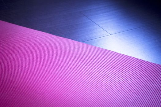 Red fitness, yoga and pilates foam mats in sports aerobics gymnasium. Artistic photo. 