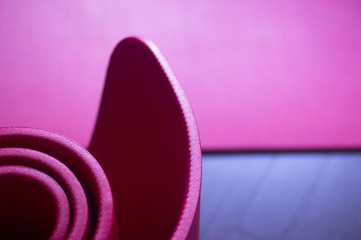 Red fitness, yoga and pilates foam mats in sports aerobics gymnasium. Artistic photo. 