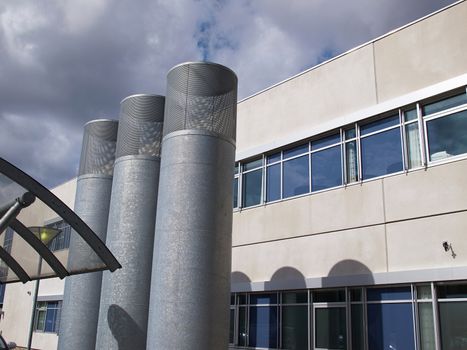Ventilation metal vertical pipes of light industrial building  