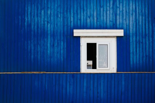 window on the blue wooden wall