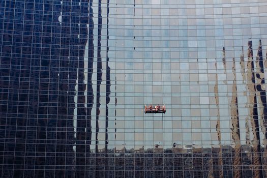 workers are leaning glass wall
