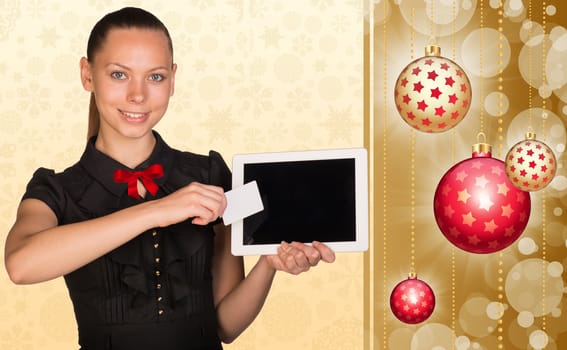 Beautiful businesswoman holding blank tablet PC and blank business card in front of PC screen
