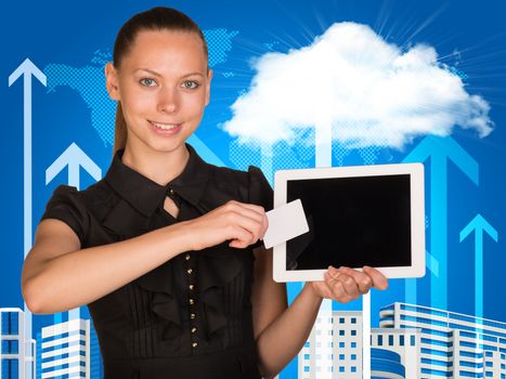 Beautiful businesswoman holding blank tablet PC and blank business card in front of PC screen. World map, buildings, clouds and vertical arrows as backdrop